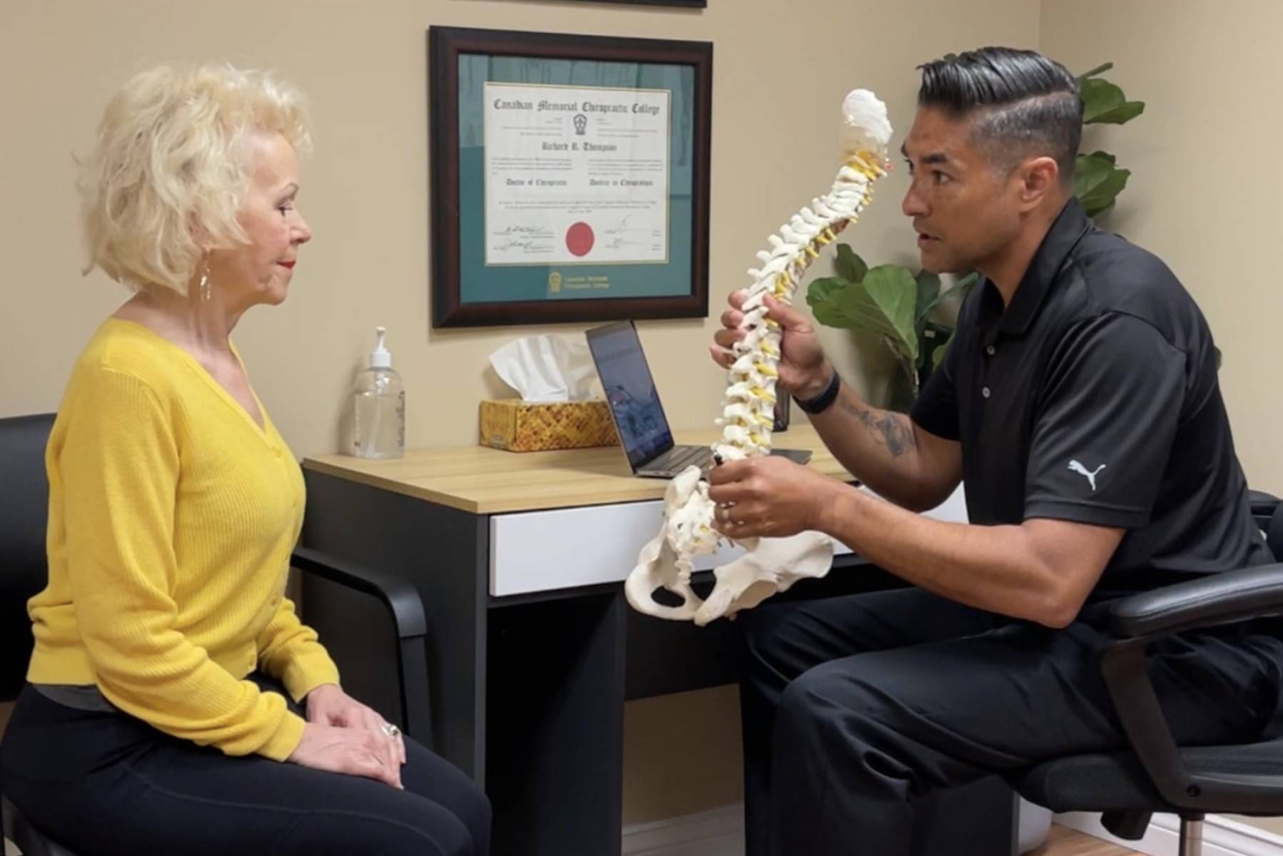 A Woman Sitting In A Chair While Doctor Explains